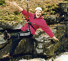 Adventure activity holiday with girl on a tyrolean crossing a river
